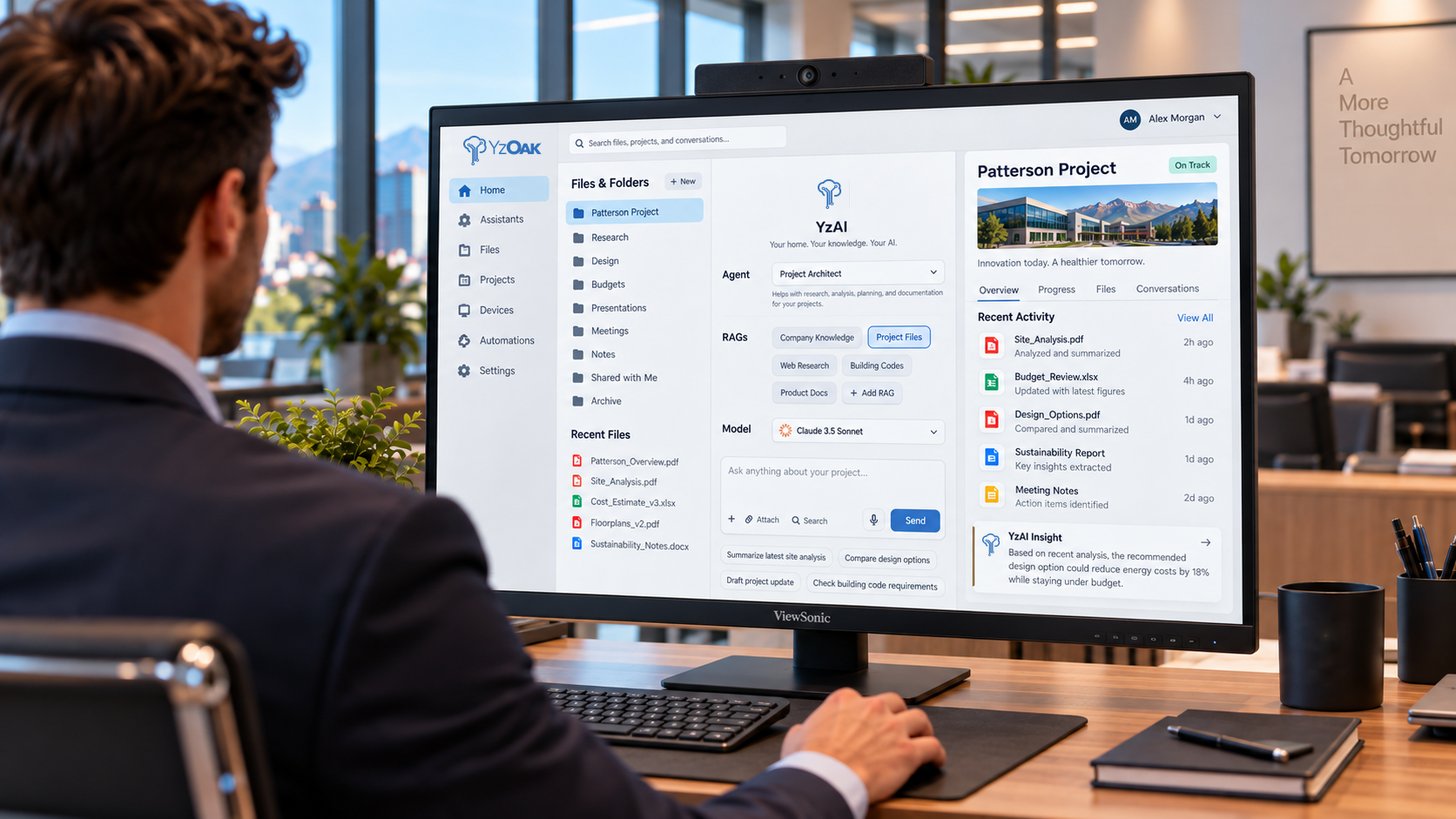 YzApp displayed on a workplace monitor with project files, AI chat, model and agent selection, and Patterson Project context.